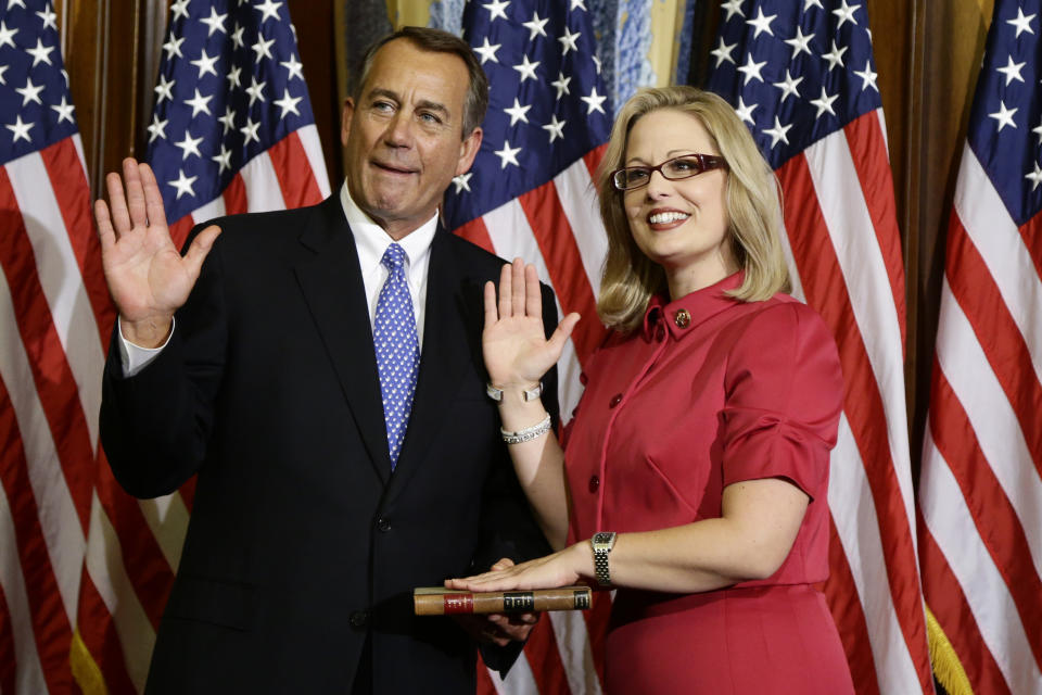 House Speaker John Boehner of Ohio performs a mock swearing in for Rep. Kyrsten Sinema, D-Ariz., Thursday, Jan. 3, 2013, on Capitol Hill in Washington as the 113th Congress began. (AP Photo/Charles Dharapak) 