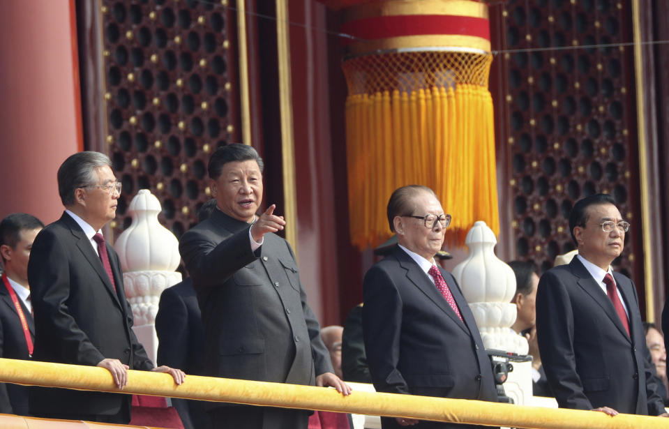 Chinese President Xi Jinping, center left, with former presidents Jiang Zemin, center right, and Hu Jintao, left, and Premier Li Keqiang, right, attend the celebration to commemorate the 70th anniversary of the founding of Communist China in Beijing, Tuesday, Oct. 1, 2019. (AP Photo/Ng Han Guan)