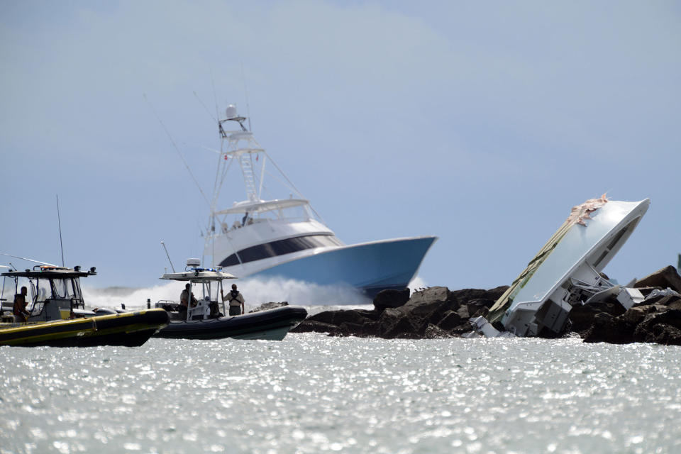 <p>Investigators look at a boat overturned on a jetty, Sunday, Sept. 25, 2016, off Miami Beach, Fla. Authorities said that Miami Marlins starting pitcher Jose Fernandez was one of three people killed in the boat crash early Sunday morning. Fernandez was 24. (Joe Cavaretta/South Florida Sun-Sentinel via AP) </p>