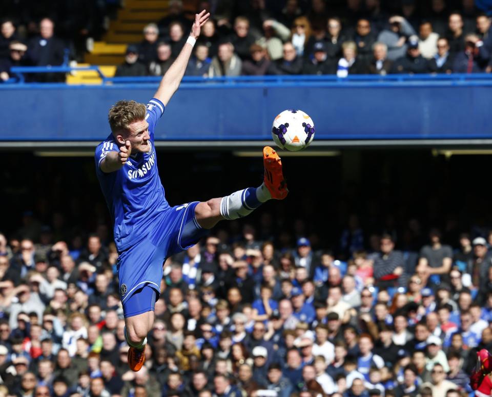 Chelsea's Schurrle jumps for the ball during their English Premier League soccer match against Arsenal at Stamford Bridge in London