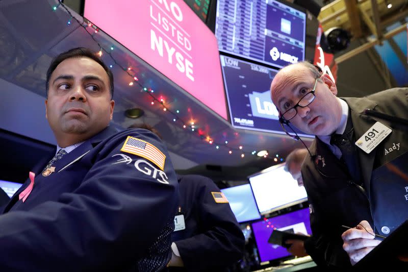 Traders work on the floor at the NYSE in New York