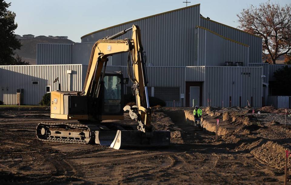 A construction worker compacts the dirt in a trench for the foundation of the new Clearwater Lofts construction project at 7275 W. Clearwater Ave. in Kennewick. The building will offer residential and commerical space.