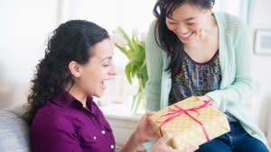 Woman giving friend birthday present