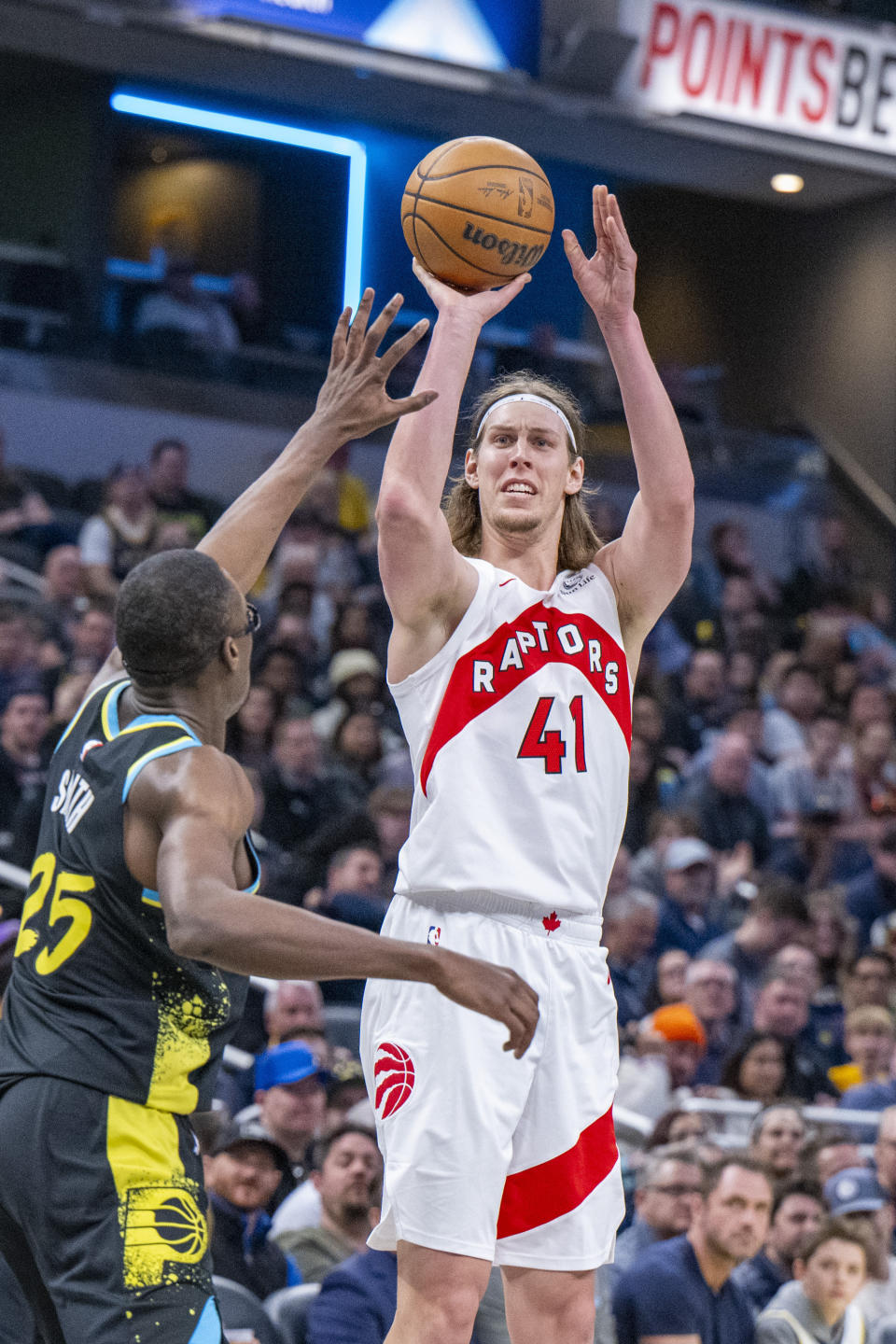 Toronto Raptors forward Kelly Olynyk (41) shoots over the defense of Indiana Pacers forward Jalen Smith (25) during the second half of an NBA basketball game in Indianapolis, Monday, Feb. 26, 2024. (AP Photo/Doug McSchooler)