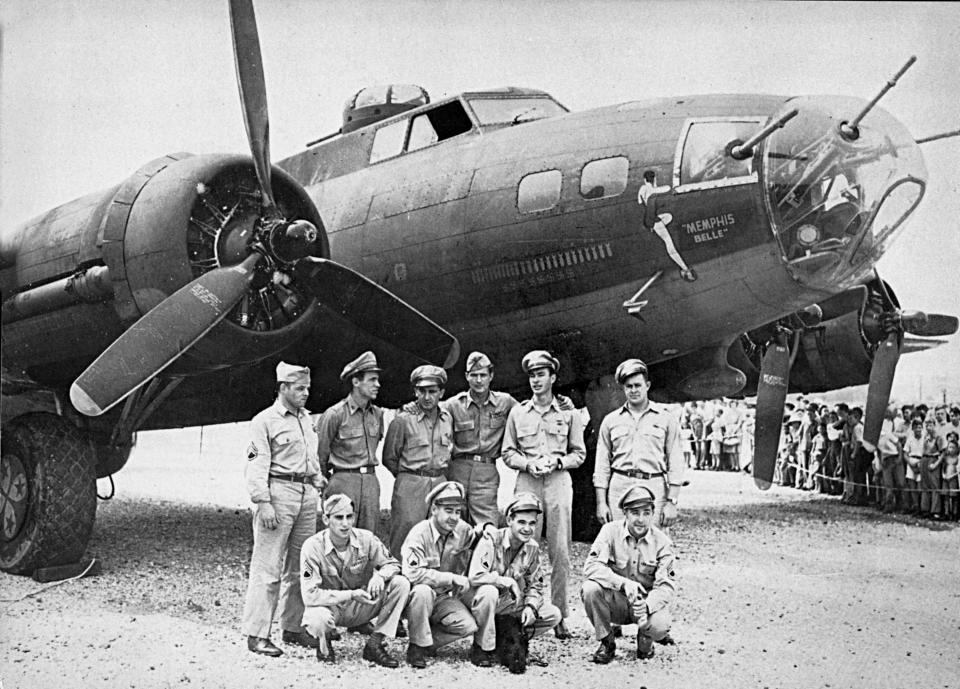FILE - This 1943 file photo shows the crew of the Memphis Belle, a Flying Fortress B-17F, poses in front of their plane in Asheville, N.C. Standing from left to right: tail gunner John P. Quinlan of Yonkers, N.Y.; nose gunner Charles B. Leighton of East Lansing, Mich.; co-pilot James Verinis of New Haven, Conn.; pilot Robert K. Morgan of Asheville, N.C.; bombardier Vincent Evans of Buellton, Calif.; radio operator Robert J. Hansen of Billings, Montana. Kneeling from left to right: waist gunner C.A. Nastal of Arlington Heights, Ill.; ball turret gunner Cecil H. Scott of Iselin, N.Y.; waist gunner C.E. Winchell of Barrington, Ill.; and navigator Harold P. Lock of Green Bay, Wisconsin. The most celebrated American aircraft to emerge from the great war rests these days in a cavernous hangar at a southern Ohio Air Force base undergoing a loving and fastidious restoration _ from its clear plastic nose cone down to the twin .50-caliber machine guns bristling in the tail. (AP Photo, file)