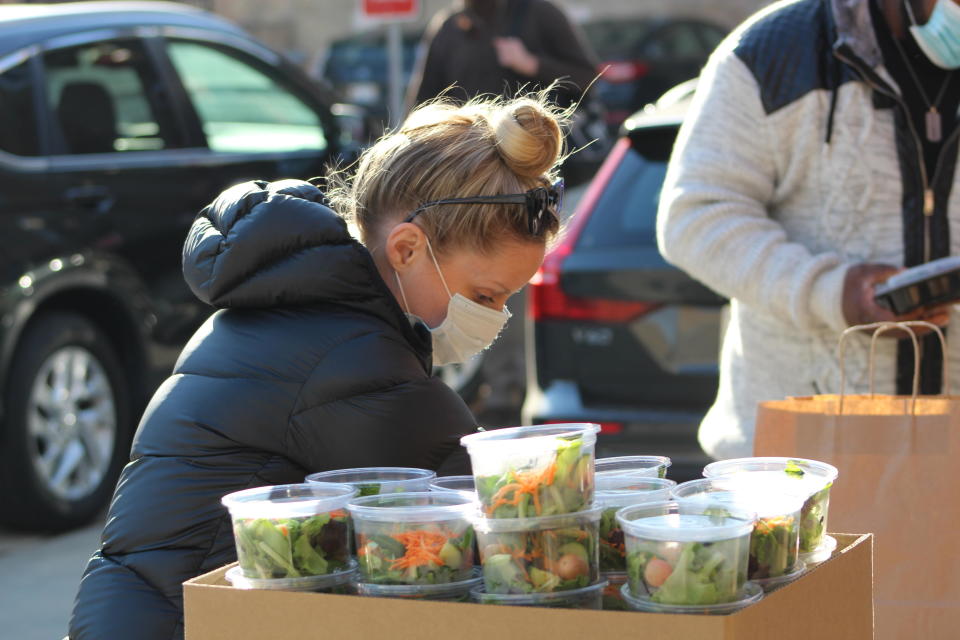 Emily Bugg packing Thanksgiving meals for Thresholds clients. / Credit: Thresholds