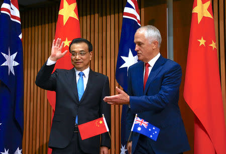 Australia's Prime Minister Malcolm Turnbull gestures to Chinese Premier Li Keqiang at the end of an official signing ceremony at Parliament House in Canberra, Australia, March 24, 2017. REUTERS/David Gray