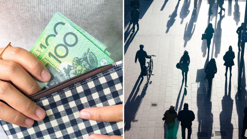 Close up of hands holding purse with Australian $100 notes, silhouetted pedestrians in busy street. 