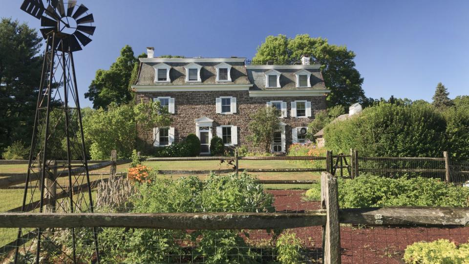 colonial stone home on a farm