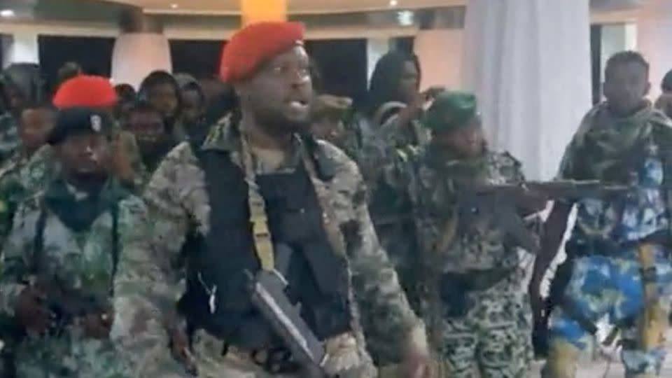 A man in military fatigues speaks as others stand next to him inside the Palace of the Nation during an attempted coup in Kinshasa, Democratic Republic of Congo, May 19, 2024 in this screen grab from a social media video. - Christian Malanga/Reuters