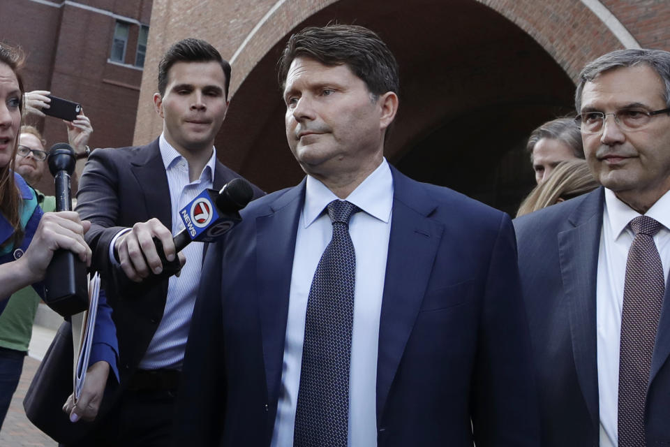 Devin Sloane, middle, leaves federal court after his sentencing in a nationwide college admissions bribery scandal, Tuesday, Sept. 24, 2019, in Boston. (AP Photo/Elise Amendola)