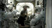 NASA astronauts Chris Cassidy and Tom Marshburn don their NASA-issue Extravehicular Mobility Units for an emergency spacewalk to find an ammonia link outside the International Space Station. Canadian astronaut Chris Hadfield (center) and Russia