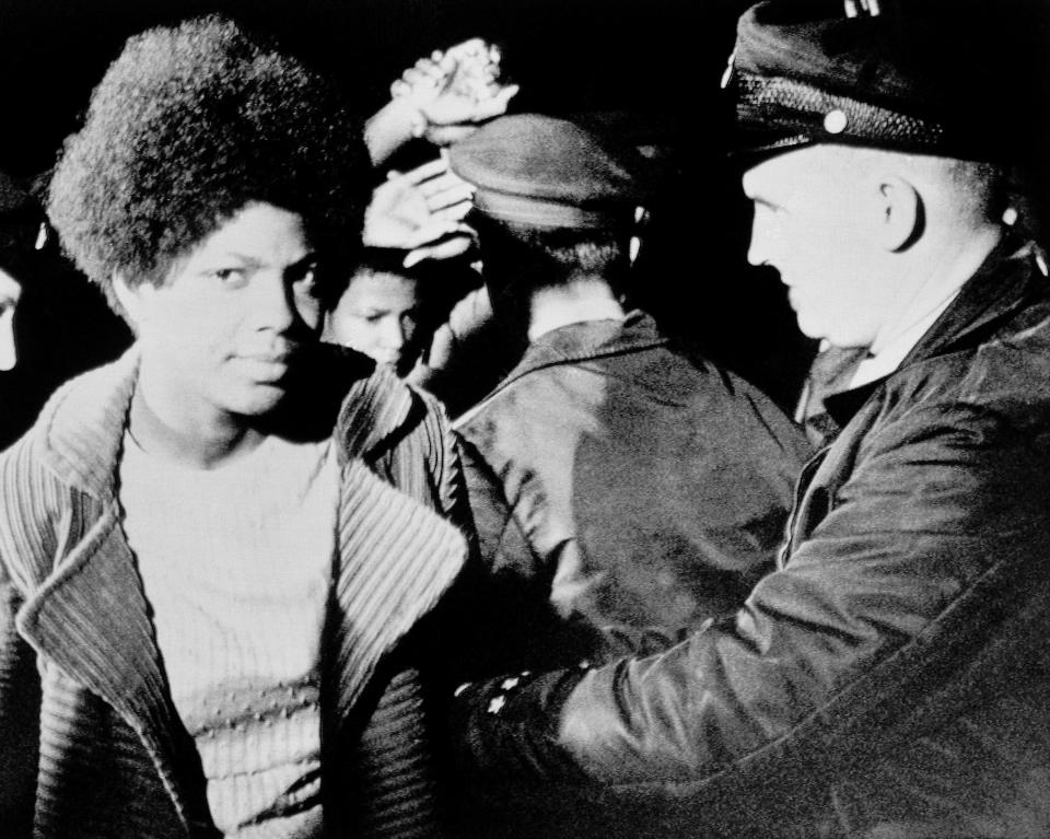 LEFT: Detroit policemen search a member of a Black Panther splinter group which surrendered after a nine-hour armed standoff in Detroit on Saturday, Oct. 25, 1970.