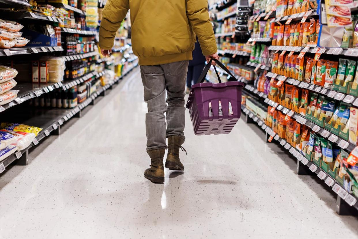 A customer browses a grocery store aisle in this file photo from February.  (Cole Burston/The Canadian Press - image credit)