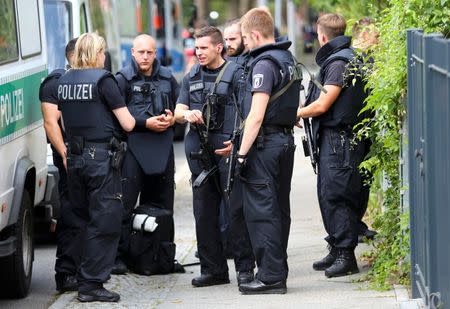 Special police stand outside the university clinic in Steglitz, a southwestern district of Berlin, July 26, 2016 after a doctor had been shot at and the gunman had killed himself. REUTERS/Hannibal Hanschke