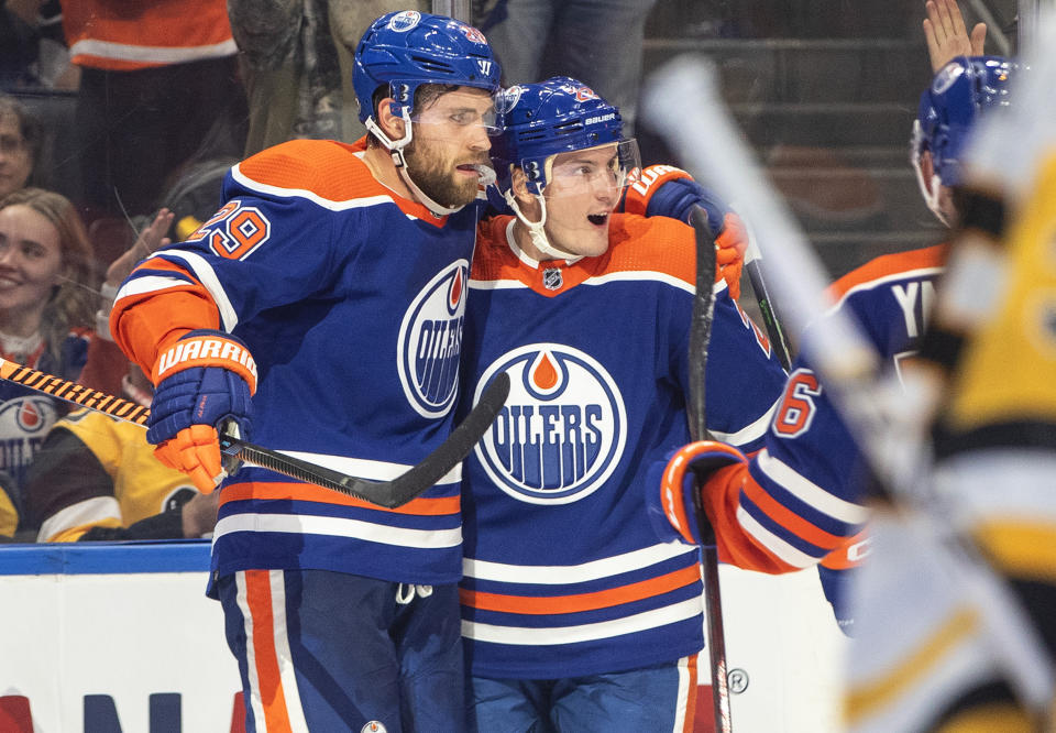 Edmonton Oilers' Leon Draisaitl (29) and Tyson Barrie (22) celebrate a goal against the Pittsburgh Penguins during second-period NHL hockey game action in Edmonton, Alberta, Monday, Oct. 24, 2022. (Jason Franson/The Canadian Press via AP)
