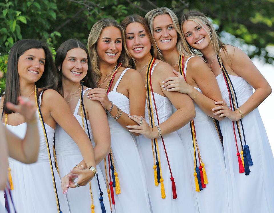 Graduates pose for a photo with friends at the Notre Dame Academy commencement ceremony in Hingham on Friday, May 20, 2022.