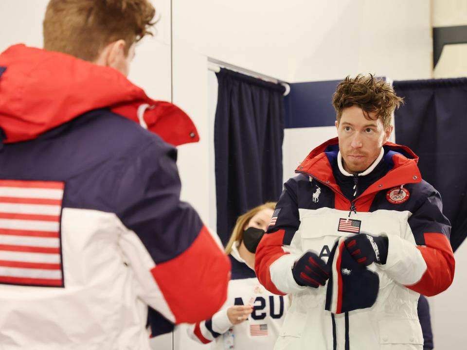 Shaun White looking in the mirror in snow jacket