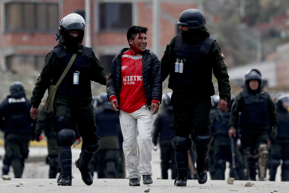 Police detain a supporter of former President Evo Morales during clashes on the south side of La Paz, Bolivia, Monday, Nov. 11, 2019. Morales' Nov. 10 resignation, under mounting pressure from the military and the public after his re-election victory triggered weeks of fraud allegations and deadly demonstrations, leaves a power vacuum and a country torn by protests against and for his government. (AP Photo/Juan Karita)