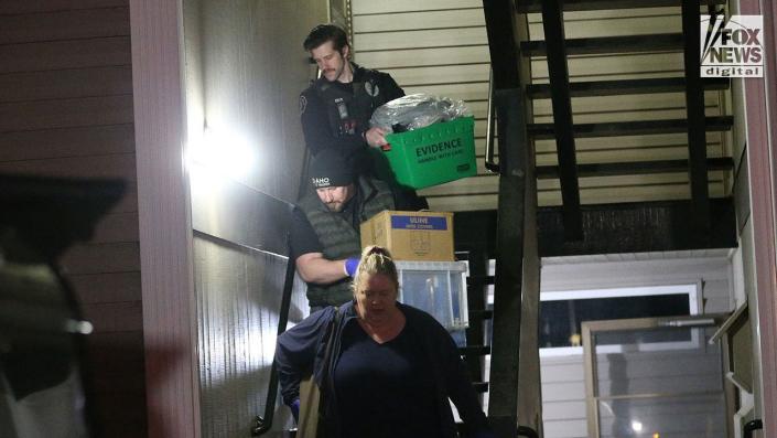 Investigators carry boxes out of Kohberger's Pullman apartment