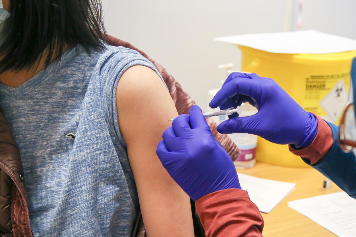 A health worker administers the Pfizer/BioNTech Covid-19 booster jab to a woman at a vaccination centre. (Photo by Dinendra Haria / SOPA Images/Sipa USA)