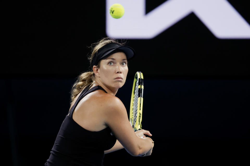 Danielle Collins of the U.S. plays a backhand return to Iga Swiatek of Poland during their semifinal match at the Australian Open tennis championships in Melbourne, Australia, Thursday, Jan. 27, 2022. (AP Photo/Hamish Blair)