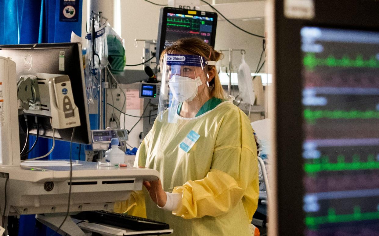 A nurse works on a computer in the ICU (Intensive Care Unit) in St George's Hospital in Tooting - Victoria Jones/PA