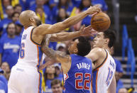 Oklahoma City Thunder guard Derek Fisher (6) reaches for a rebound over Los Angeles Clippers forward Matt Barnes (22) in the fourth quarter of Game 2 of the Western Conference semifinal NBA basketball playoff series in Oklahoma City, Wednesday, May 7, 2014. Oklahoma City won 112-101. Thunder center Steven Adams (12) is at right. (AP Photo/Sue Ogrocki)