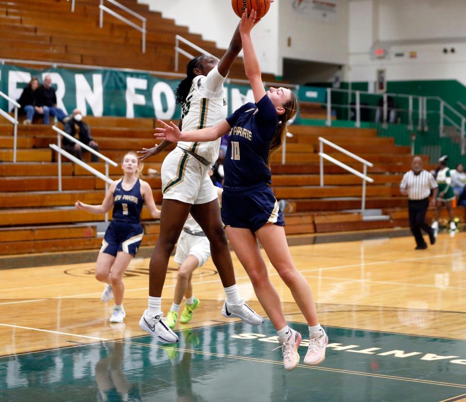 South Bend Washington junior Monique Mitchell blocks the shot of New Prairie senior Jolie Johns in the third quarter of a girls basketball game Thursday, Nov. 30, 2023, at Washington High School in South Bend.