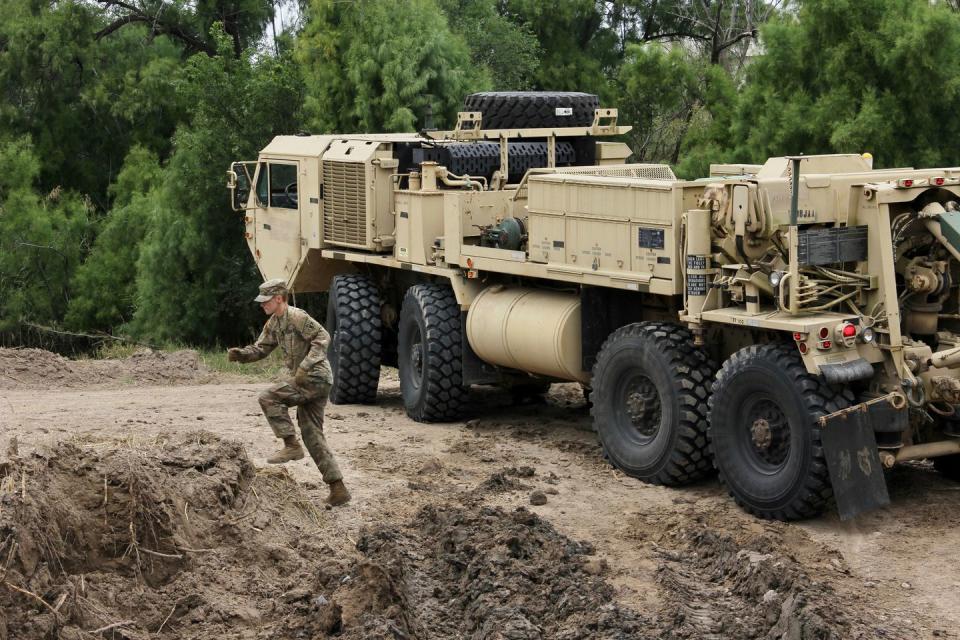 <p>A military tow truck is seen after it hauled a Humvee that had been stuck in the mud on the banks of the Rio Grande on November 18, 2018. - Soldiers from the Kentucky-based 19th Engineer Battalion are working in Laredo to install fencing as part of a military deployment ordered by President Donald Trump to harden the US-Mexico border and provide engineering and logistical support to Customs and Border Protection agents.</p>
