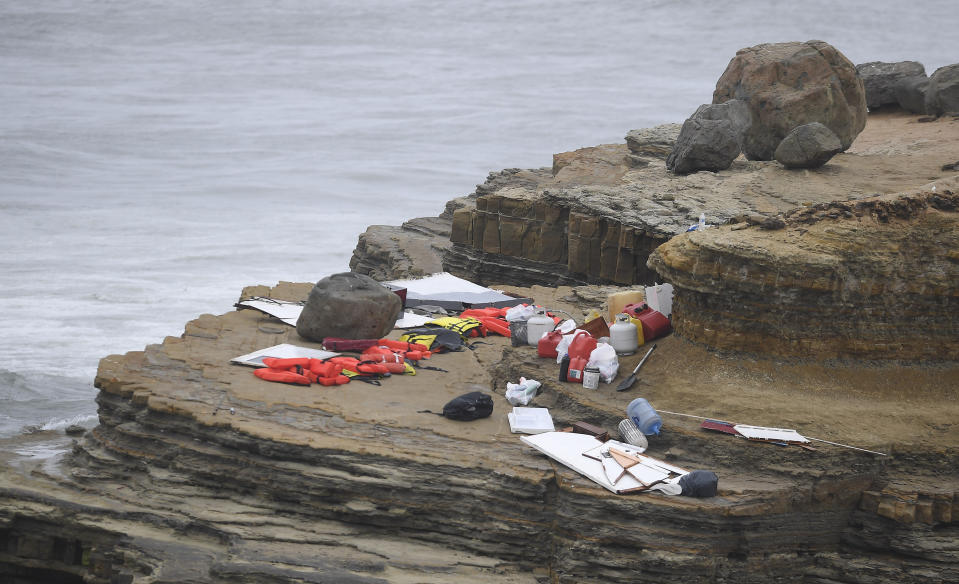 Items from a boat sit on the shoreline at Cabrillo National Monument near where it capsized just off the San Diego coast Sunday, May 2, 2021, in San Diego. Authorities say two people were killed and nearly two dozen others were hospitalized after the boat capsized. (AP Photo/Denis Poroy)