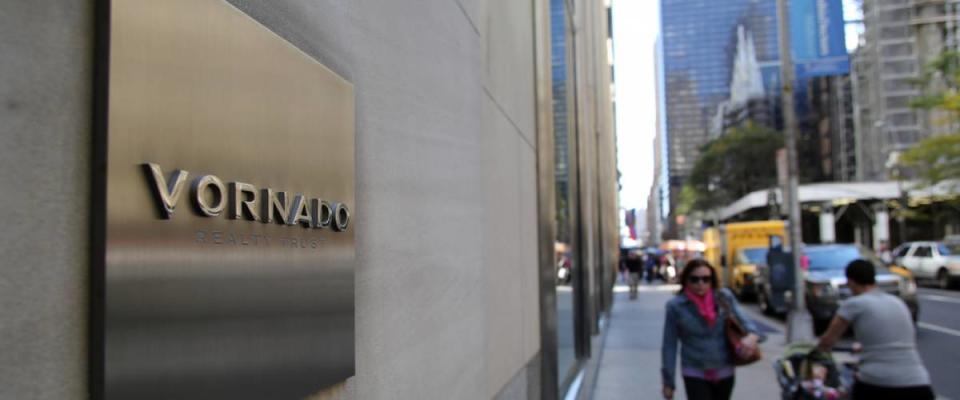 Pedestrians walk past a building managed by Vornado Realty Trust in Manhattan on Friday, October 18, 2013.