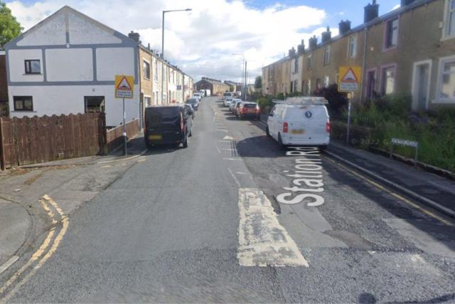 Road closed and traffic building after lorry crashed into building