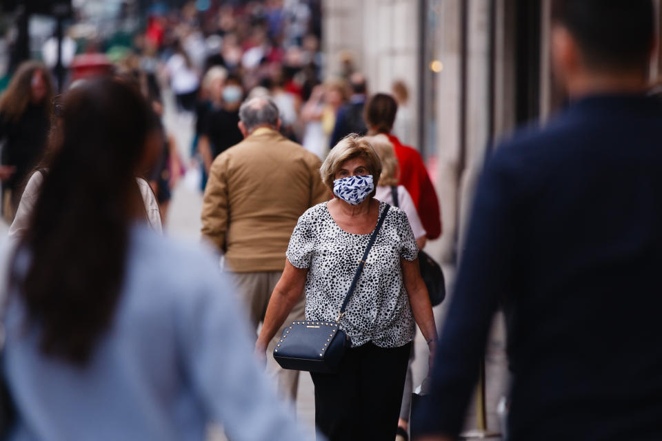 A woman wearing a face mask walks along Regent Street in London, England, on September 22, 2020. British Prime Minister Boris Johnson this afternoon announced a raft of new coronavirus restrictions to apply across England, possibly to last the next six months, including requiring pubs and restaurants to close at 10pm and for retail staff to all wear face masks. A return to home working where possible is also being encouraged. The new measures come amid fears of a 'second wave' of covid-19 deaths prompted by rising numbers of people testing positive in recent weeks. (Photo by David Cliff/NurPhoto via Getty Images)