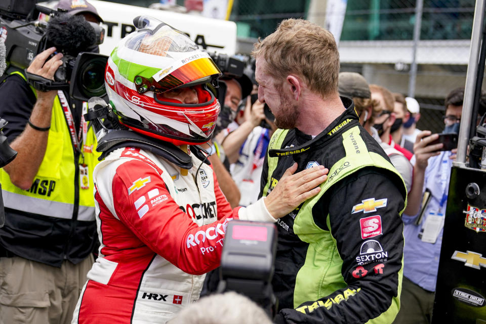 Simona De Silvestro of Switzerland, left, consoles Charlie Kimball after he failed to make the field during the last row qualifications for the Indianapolis 500 auto race at Indianapolis Motor Speedway in Indianapolis, Sunday, May 23, 2021. (AP Photo/Michael Conroy)