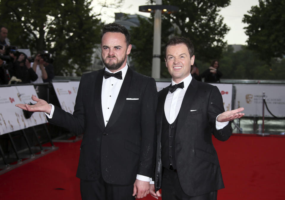 TV presenters Ant and Dec pose for photographers in the rain, upon arrival to the British Academy Television Awards at the Royal Festival Hall in London, Sunday, May 14, 2017. (Photo by Joel Ryan/Invision/AP)