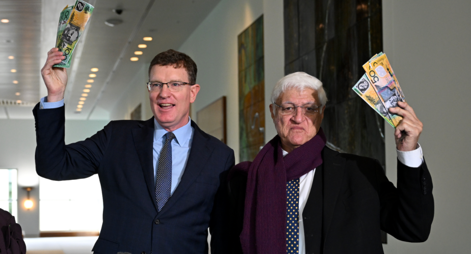 MPs Andrew Gee and Bob Katter holding up Australian money