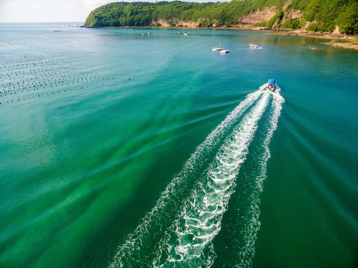 Aerial View Of Ship Sailing In Blue Sea