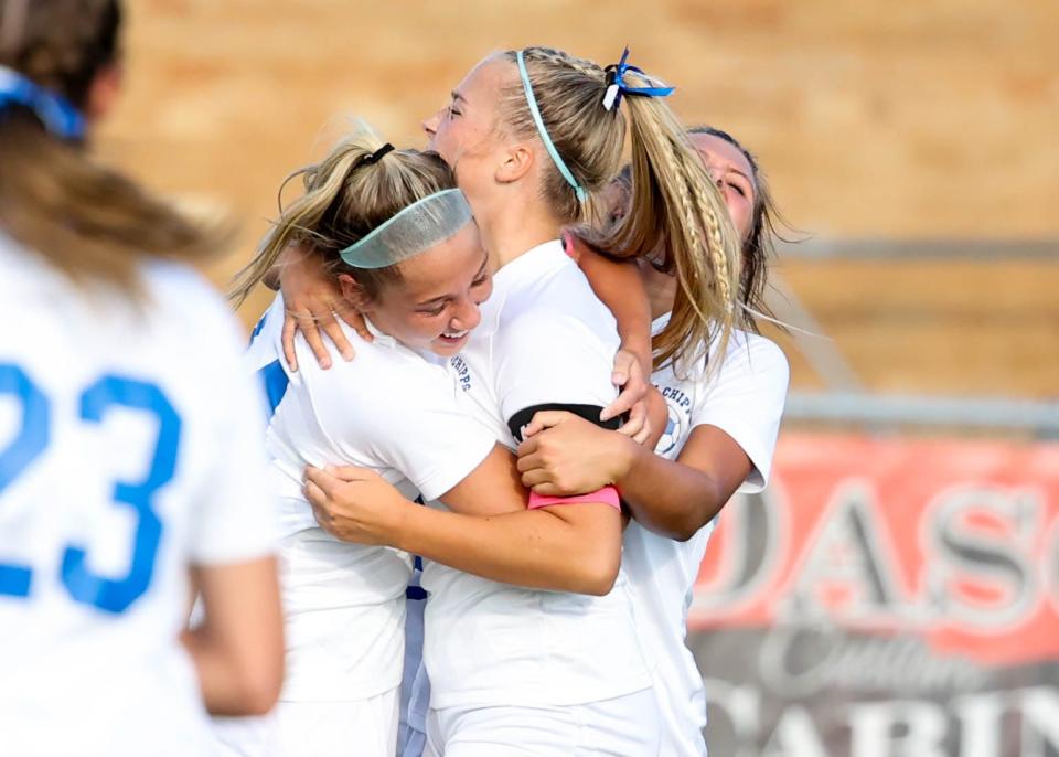 Chippewa's Annie Henegar (right) hugs Lauren Beach (left) after scoring the game's first goal in the first half.