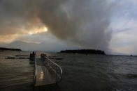 <p>A wildfire is visible from Leek’s Marina on the shore of Jackson Lake, in Grand Teton National Park, Wyo., Aug. 24, 2016. (AP Photo/Brennan Linsley) </p>