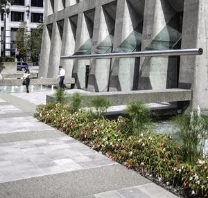 Multi-award-winning Arthur Erickson Place, made of reinforced bare concrete, rises above a spacious public plaza with reflecting pools that span the building’s length.