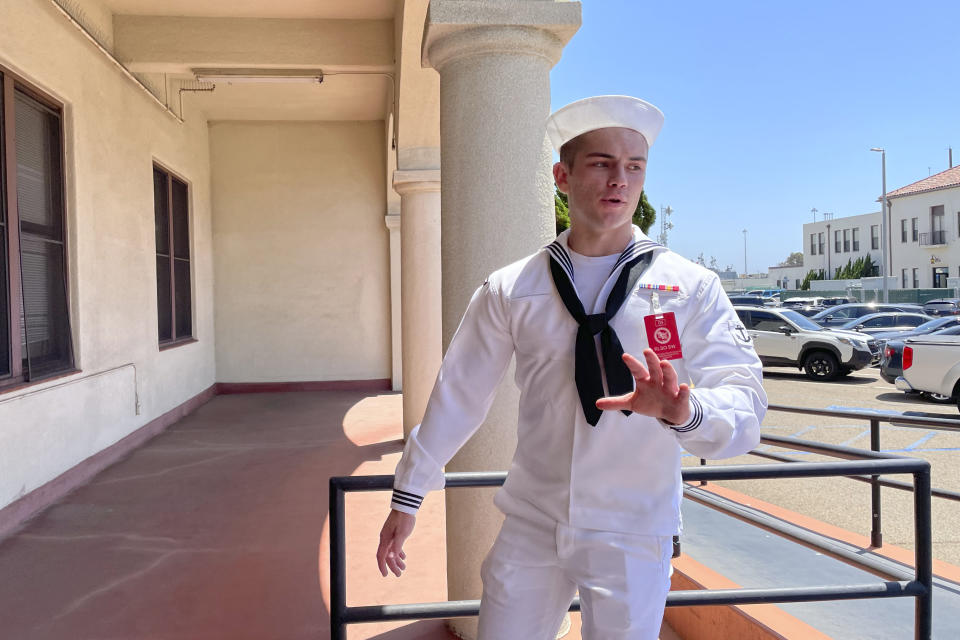 US Navy sailor Ryan Sawyer Mays walks past reporters at Naval Base San Diego before entering a Navy courtroom Wednesday, Aug. 17, 2022, in San Diego. Mays is accused of setting the USS Bonhomme Richard on fire, and his court martial is scheduled to begin Monday, Sept. 19, 2022. The July 2020 blaze damaged the billion-dollar warship so badly it had to be scuttled and marked one of the worst noncombat US warship disasters in recent memory. (AP Photo/Julie Watson)