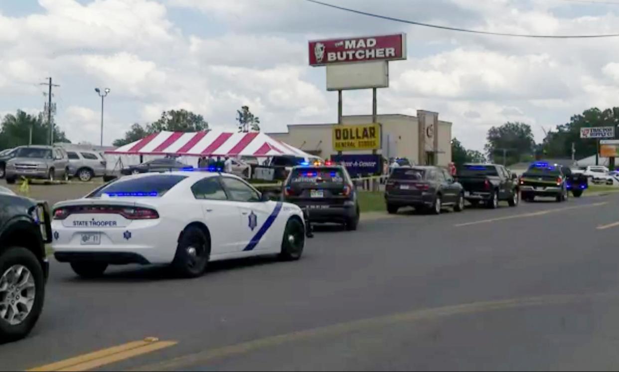 <span>Police respond to the scene of a shooting on Friday in Fordyce, Arkansas, before a weekend spate of shootings across US.</span><span>Photograph: AP</span>