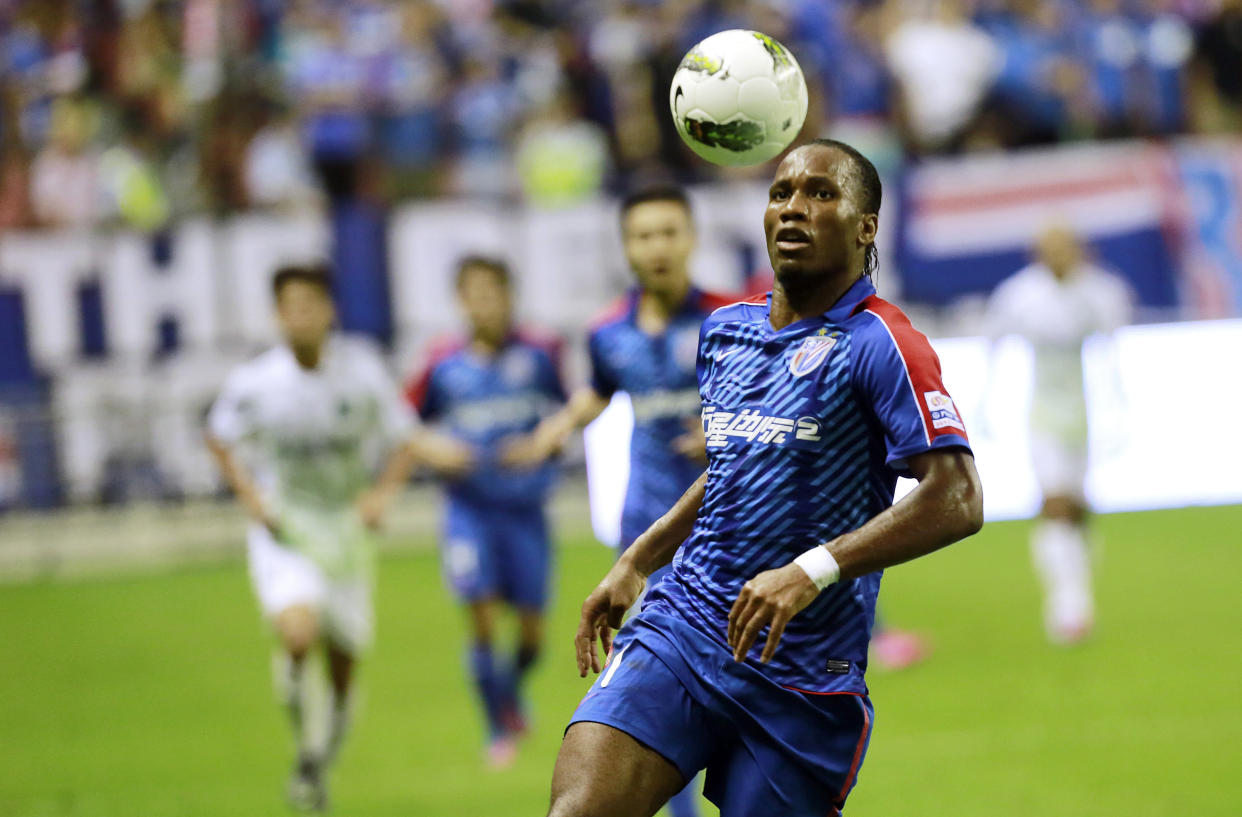 FILE - Shanghai Shenhua's Didier Drogba controls the ball during a soccer match against Hangzhou Greentown at Hongkou Football Stadium on Aug. 4, 2012 in Shanghai, China. Cristiano Ronaldo is not the first soccer superstar to head off to one of the world’s supposed minor leagues in the latter years of his career. Many of soccer's biggest names like Pelé, Johan Cruyff, Zico, Xavi Hernandez and now the 37-year-old Ronaldo at Saudi Arabian club Al Nassr have found themselves prolonging their careers at unlikely soccer outposts usually for vast amounts of money. (AP Photo/Eugene Hoshiko, File)