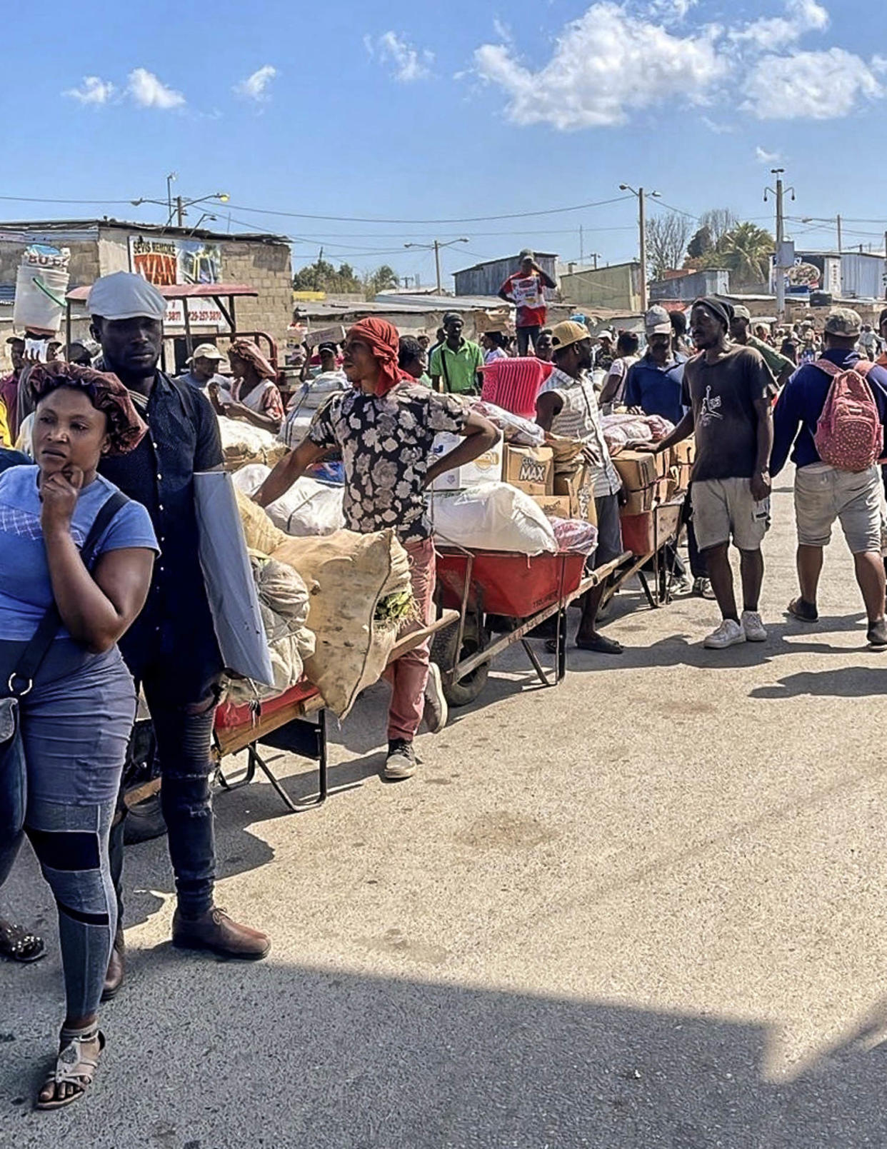 Haitians allowed into a farmer’s market in the border town of Dajabón Thursday return with food. (Gabe Gutierrez / NBC News)