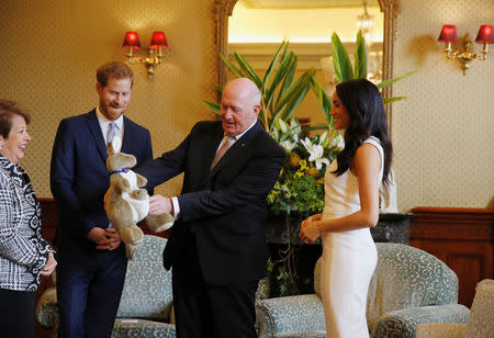 Britain's Prince Harry and wife Meghan, Duchess of Sussex look at a plush kangaroo with Australia's Governor General Peter Cosgrove and wife Lynne Cosgrove at Admiralty House during their visit in Sydney, Australia October 16, 2018. REUTERS/Phil Noble/Pool