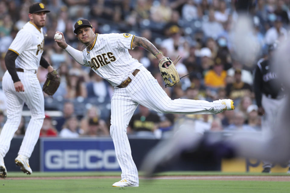 San Diego Padres third baseman Manny Machado attempts to throw out Colorado Rockies' Brendan Rodgers during the first inning of a baseball game Thursday, July 29, 2021, in San Diego. Rodgers was safe. (AP Photo/Derrick Tuskan)