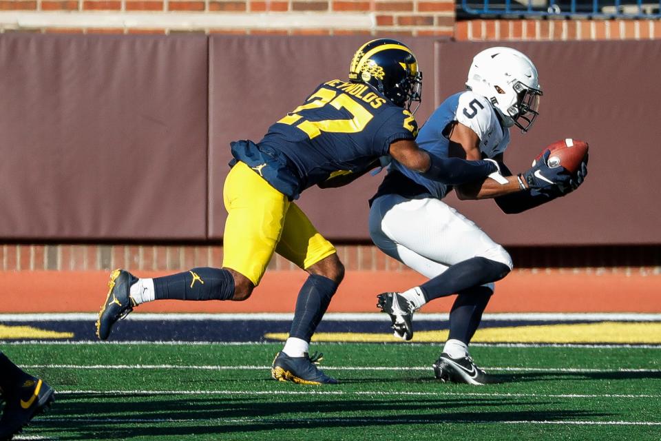 Michigan defensive back George Johnson tackles Penn State wide receiver Jahan Dotson during the second half of Michigan's 27-17 loss at Michigan Stadium on Saturday, Nov. 28, 2020.