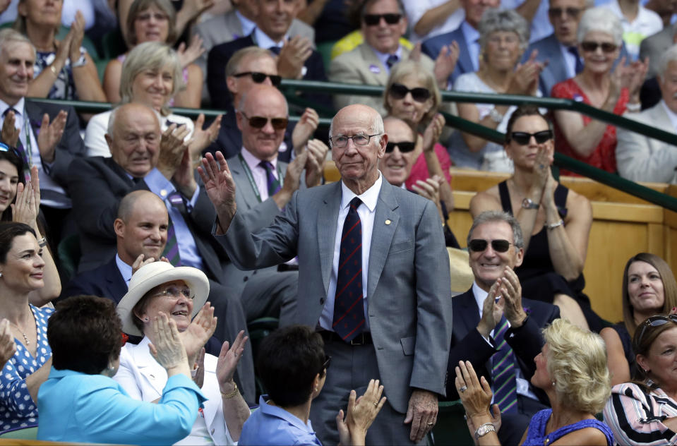 FILE - Former England soccer player Bobby Charlton stands in the Royal Box on Centre Court to receive applause from the crowd on the sixth day of the Wimbledon Tennis Championships in London, July 7, 2018. Bobby Charlton, an English soccer icon who survived a plane crash that decimated a Manchester United team destined for greatness to become the heartbeat of his country's 1966 World Cup-winning team, has died. He was 86. A statement from Charlton's family, released by United, said he died Saturday Oct. 21, 2023 surrounded by his family. (AP Photo/Kirsty Wigglesworth, File)