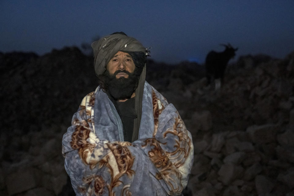 Mullah Abdul Basir, who lost five members of his family in the earthquake, stands for a photo in the area of his destroyed house in Zenda Jan district in Herat province, western of Afghanistan, Sunday, Oct. 8, 2023. Powerful earthquakes killed at least 2,000 people in western Afghanistan, a Taliban government spokesman said Sunday. It's one of the deadliest earthquakes to strike the country in two decades. (AP Photo/Ebrahim Noroozi)
